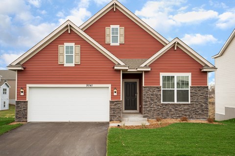 A red house with a white garage door.